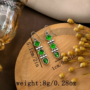 Detailed view of vintage turquoise earrings on wood tray with size specs and measurements