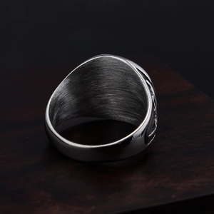 Brushed silver stainless steel microphone ring on dark wood display with high-end texture