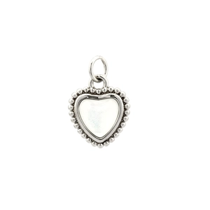 Detail of silver heart pendant with white pearlescent inlay and beaded edge design