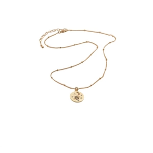 Detailed view of gold celestial pendant with moon and star charms on a ball chain