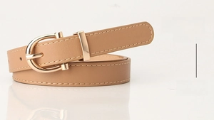 Close-up of khaki PU leather belt with a polished gold horseshoe buckle detail