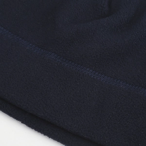 Detail of dark blue thermal fleece fabric and reinforced stitching for cycling cap
