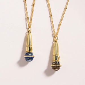 Close-up of gold microphone pendants with blue and black mesh heads on fine chains