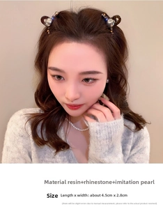 Detail showing elegant hair clip with pearls and rhinestones worn on the side of head