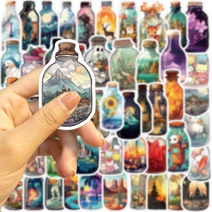 Detailed view of hand holding creative landscape bottle sticker showing precision cutting