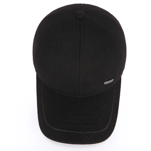 Minimalist black wool baseball cap with ear protection and a side metal logo tag