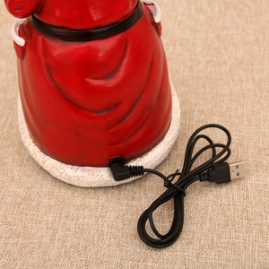 Close-up of the USB power interface and DC plug input on the red Christmas ornament