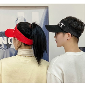 Detail view of red and black knitted sun visors with SPORT embroidery on models