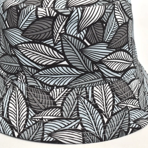 Detail of leaf print bucket hat showing reinforced stitching and durable canvas texture