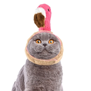 Close-up of a pink plush flamingo hat for cats with soft textures and secure velcro strap