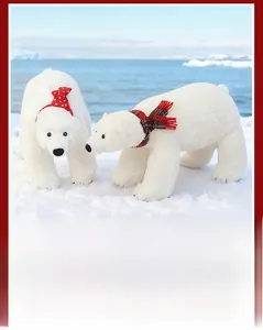 Plush polar bear set with red Christmas hat and scarf in a snowy winter scene
