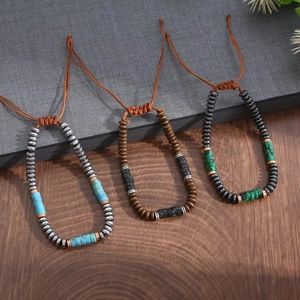 Three handmade beaded bracelets with turquoise and brown woven cords on wood