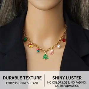 Detailed view of gold necklace with Christmas charms worn on a black blazer mannequin