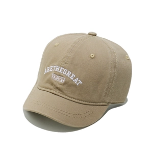 Detail of khaki cotton baseball cap showing white ARETHEGREAT letter embroidery