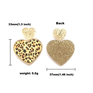 Detail view of pink leopard heart earrings showing 33mm length and 5.5g weight metrics