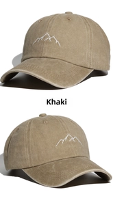 Close-up of khaki washed cotton baseball cap featuring minimalist white mountain embroidery