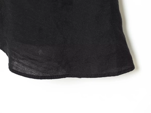 Detail view of the fine stitching and high-quality black fabric on the garment edge