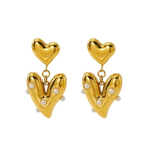 Elegant gold-colored heart-shaped earrings with delicate pearl accents on white background
