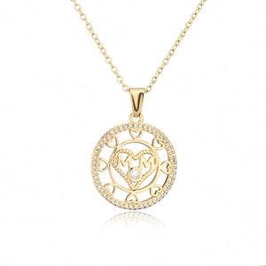 Detailed view of gold MOM pendant with heart design and sparkling zirconia crystals