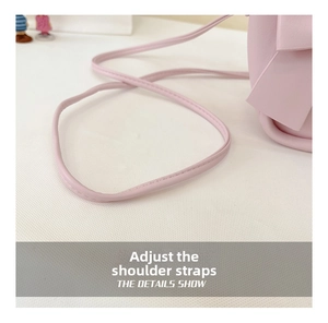 Detailed macro view of adjustable pink PU leather shoulder strap with neat stitching