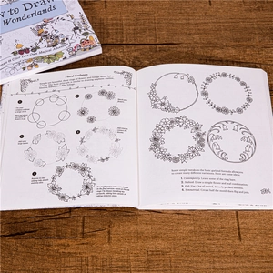 How to Draw Inky Wonderlands coloring book for adults on natural wooden desk surface