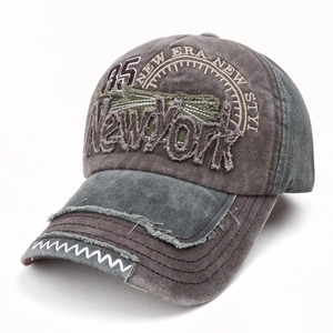 Detail of distressed embroidery and frayed edges on a vintage washed baseball cap
