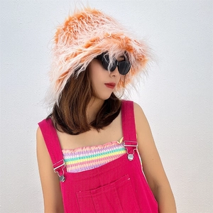 Close-up of fluffy orange-pink faux fur bucket hat with long pile texture and stylish design