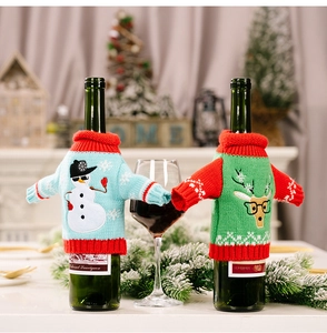 Close-up of knit Christmas wine bottle covers with snowman and reindeer patterns