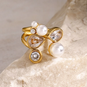 Detail of 18k gold plated ring with irregular white pearls and sparkling zircons