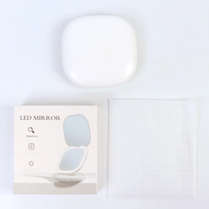 Close-up of portable LED makeup mirror set with magnifying glass and USB charging case