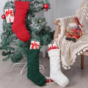 Three 46cm knitted Christmas stockings in red, green, and white hanging on a Christmas tree