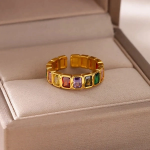 Macro shot of gold adjustable ring featuring colorful rectangular zircon stones in jewelry box