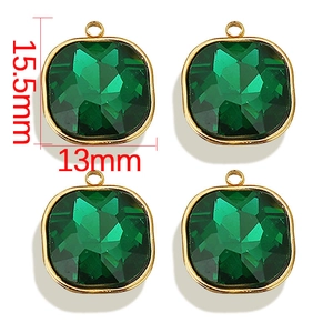 Detailed view of green square-cut glass gemstone pendants with gold bases, 15.5mm x 13mm