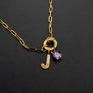 Stainless steel necklace featuring textured letter J and vibrant purple crystal pendant
