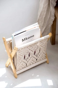Detail of bohemian cotton rope weaving and solid wood texture on a magazine rack