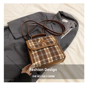 Detail of vintage brown plaid crossbody bag featuring dachshund embroidery and leather trim