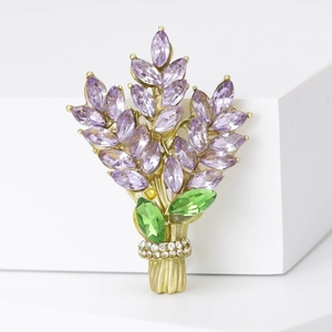 Detailed macro view of lavender brooch with purple crystals and green stone leaves