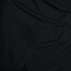 Detailed macro view of black knit fabric texture and high-quality flatlock stitching