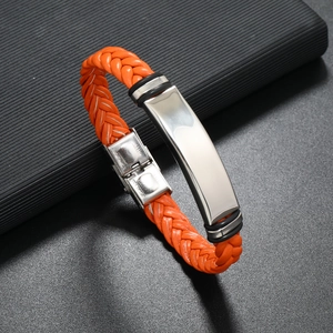 Macro shot of orange braided leather bracelet with polished stainless steel clasp