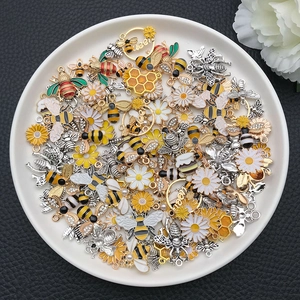 Detailed assortment of bee and daisy alloy charms with enamel finish for DIY jewelry