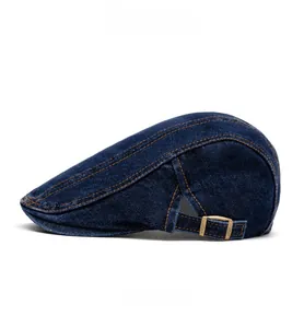 Detail view of washed navy denim ivy cap with yellow stitching and metal buckle