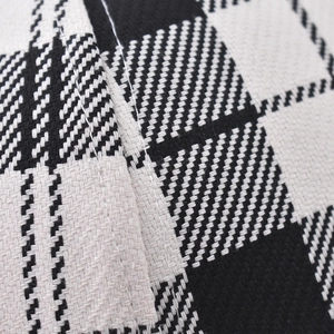 Close-up of black and white houndstooth fabric texture and detailed stitching on the baseball cap