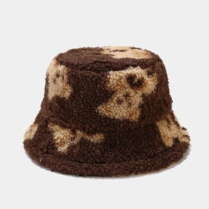 Close-up of thick brown and beige plush shearling fabric on winter bucket hat