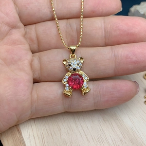 Golden bear pendant necklace with red crystal and white zircon stones on beaded chain