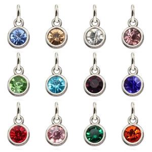Macro shot of twelve round birthstone charms with silver-plated frames in a grid layout