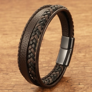 Men's multi-layer braided leather bracelet with black magnetic clasp on wood