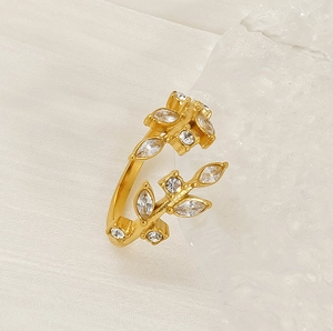 Detailed macro shot of golden leaf ring featuring shimmering white zircon crystal accents
