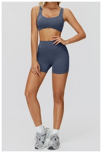 Detail view of misty blue yoga set featuring U-neck sports bra and high-waist fitness shorts