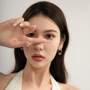 Boucles d'oreilles minimalistes en acier titane argenté avec perle sur un mannequin