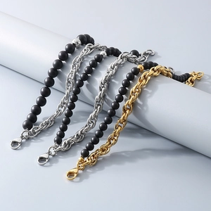Close-up of matte black onyx beads and silver twist chain bracelet with lobster clasp detail